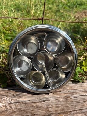 traditional stainless steel Indian masala dabba with 7 spice compartments spoon